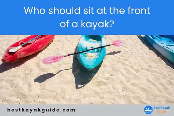 Who should sit at the front of a kayak?